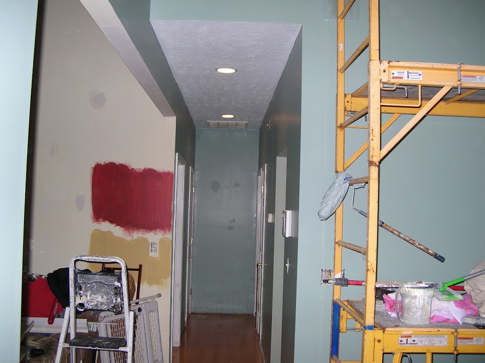 Hallway ceiling and wall renovation in progress with scaffold and fresh finish work