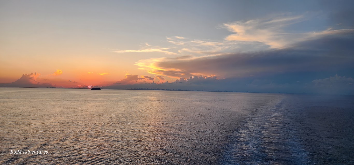 An open-ocean sunset photographed during an R&M cruise adventure